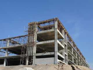Obraz premium Building reinforcement concrete structure at the construction site. Post, beam and slab constructed using timber form work by construction workers. 