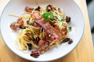 Delicious spaghetti with bacon on wooden table