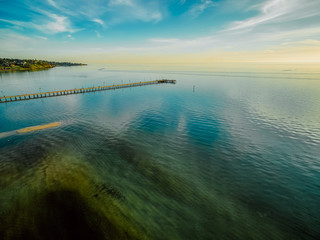 Aerial view of long wooden pier at sunset in Frankston, Victoria, Australia