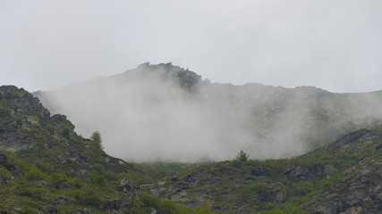 Peak mountains are surrounded by low clouds