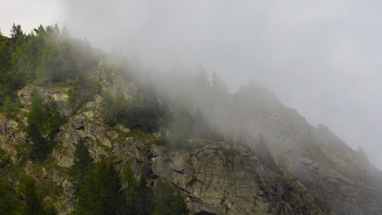 Awesome peaks mountains in the middle of mist