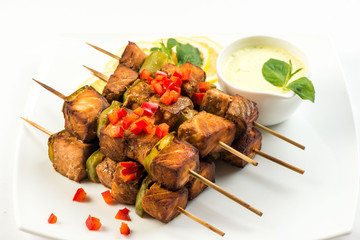 Grilled skewers of salmon and vegetables