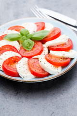 Classic caprese salad. Mozzarella tomatoes and  Basilikum.