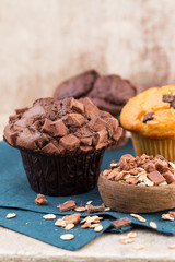 Homemade muffins with chocolate, vintage background.