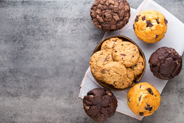 Homemade chocolate muffins on the vintage background.