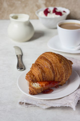 Tasty fresh croissant with jam. Breakfast.