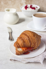Tasty fresh croissant with jam. Breakfast.