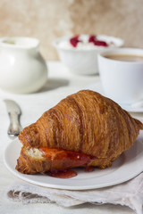 Tasty fresh croissant with jam. Breakfast.