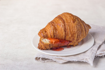 Tasty fresh croissant with jam. Breakfast.