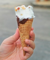 Hand Holding Ice Cream Cones with Chocolate