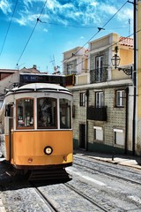 Fototapeta na wymiar Colorful trams through the streets of Lisbon in Spring