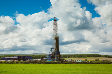 Fototapeta na wymiar Land oil drilling rig blue sky