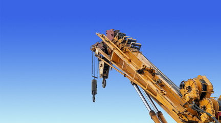 closeup yellow truck crane in construction site with soft-focus and over light in the background. [cliping path]