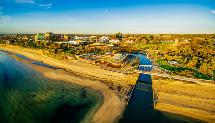 Frankston waterfront at sunset showcasing the famous footbridge over Kananook creek - aerial panorama. Melbourne, Australia