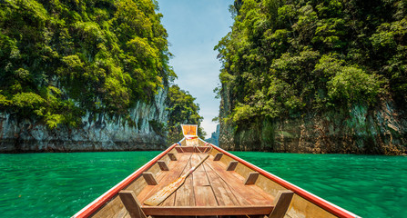 wooden longtail boat trip adventure at Ratchaprapa dam, Thailand