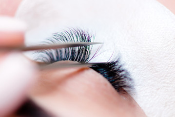 Eyelash extensions in the beauty salon. The concept of body care and beauty.
