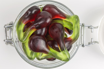 cherry gummy candy in red and green in a glass jar
