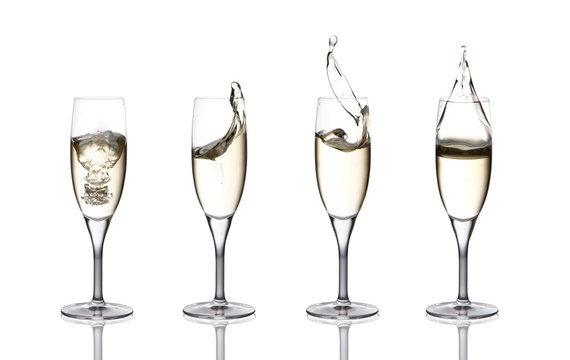 a splash of champagne in glasses on a white background
