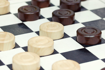 Obraz na płótnie Canvas Wooden checkers game on board closeup