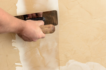Stretching the second layer of Venetian plaster by man