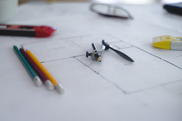 Architectural plans work space top view. Architectural project, blueprints,pencil and divider compass on wooden desk table.Construction background.Engineering tools. Copy space.Architectural Concept