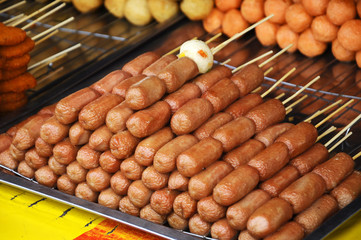 Sausages and other processed foods are packed with skewers and served on table. Sell by street...