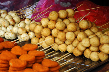 Sausages and other processed foods are packed with skewers and served on table. Sell by street...