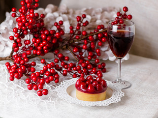 A beautiful still life from a glass of wine and dessert with berries.