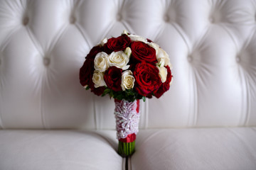 Beautiful wedding bouquet of white and red roses.