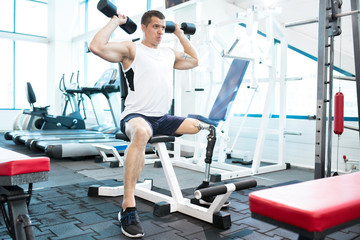 Fototapeta na wymiar Young disabled man keeps himself in shape in gym