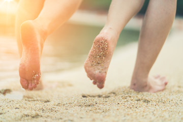 Beach travel lifestyle concept. woman Legs on Tropical Sand Beach. Walking Female Feet Closeup