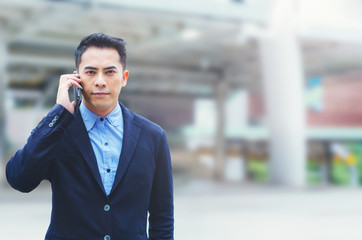portrait attractive handsome businessman talking on smartphone at outdoor.