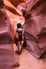 cute woman in black hat and dress in Magnificent antelope canyon in Arizona, USA.