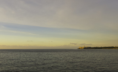 Naklejka na ściany i meble Sunset over Malecon and Atlantic Ocean with Morro Castle in background - Havana, Cuba 