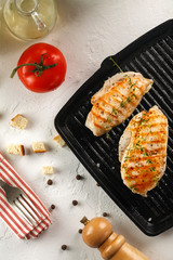grilled chicken with spices on black grill pan