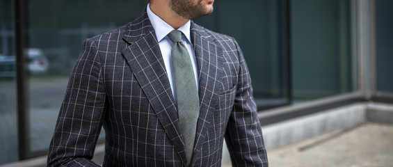 Man in custom tailored business suit posing outdoors