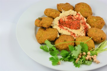 Falafel on a plate around hummus