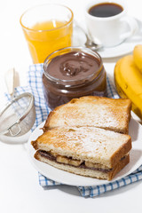 sweet sandwich with chocolate paste and banana for breakfast, vertical