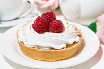 sweet tartlet with meringue and raspberry, closeup