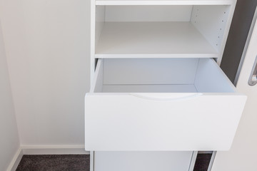 Open drawer in white cupboard