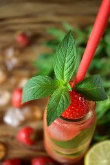 Fresh mint on top of a bottle of strawberry lemonade