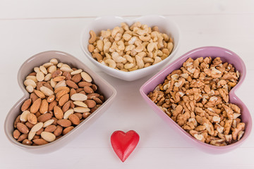 healthy brain heart food nuts in heart shape dish on white wood background 