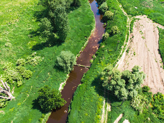 Fototapeta premium dirty brown river. pollution concept. green riverside