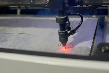 Closeup of programmable laser cutting machine engraving picture