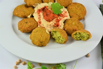 Falafel on a plate around hummus