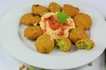 Falafel on a plate around hummus