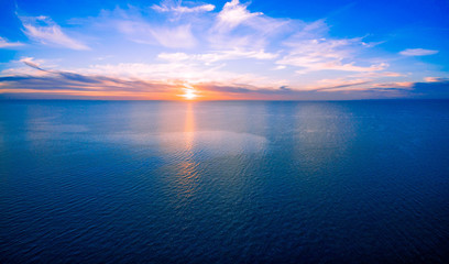 Sun setting over ocean - minimalist sunset aerial panorama