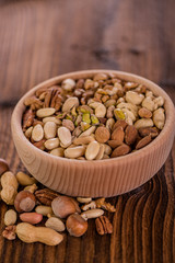 wooden bowl full of different muxture variety of nuts 