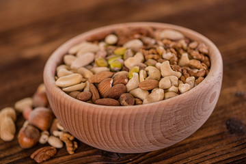 wooden bowl full of different muxture variety of nuts 