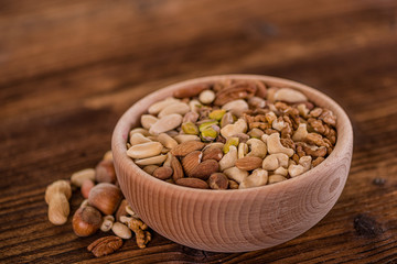 wooden bowl full of different muxture variety of nuts 